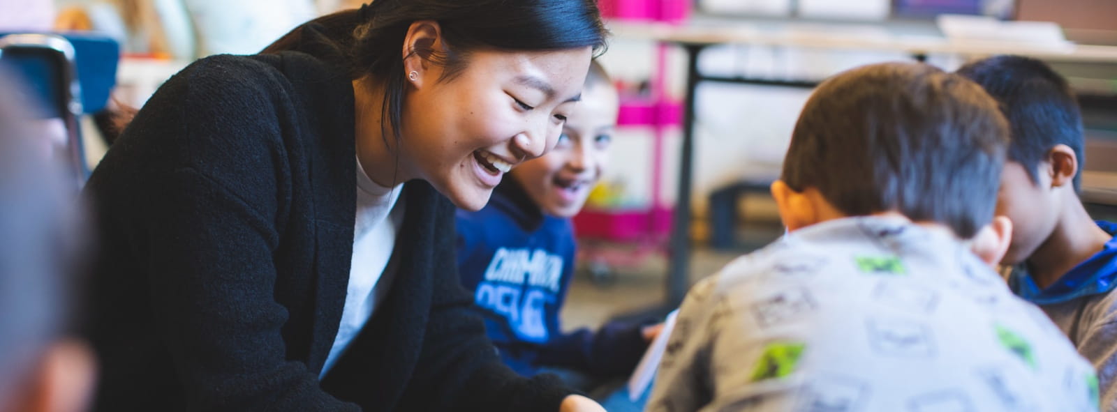 A student-teacher from the School of Education interacts with elementary school children in the classroom