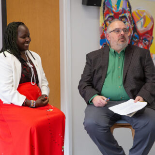 Faculty member Mike Gunzenhauser speaks with Pitt alumna Kakenya Ntaiya at a school presentation