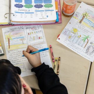 Bird's-eye view of a young student writing on a worksheet