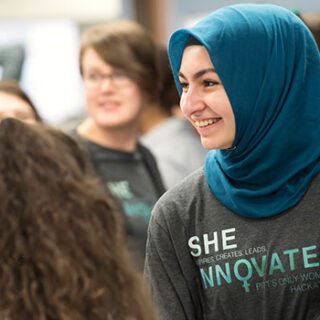 A student talks to a group of other students