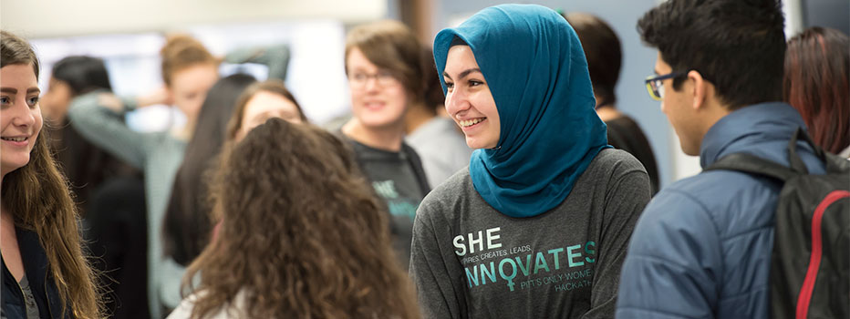 A student talks to a group of other students