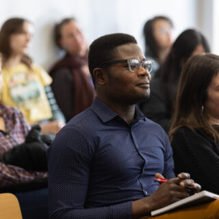 A student in a presentation listening intently to the speaker