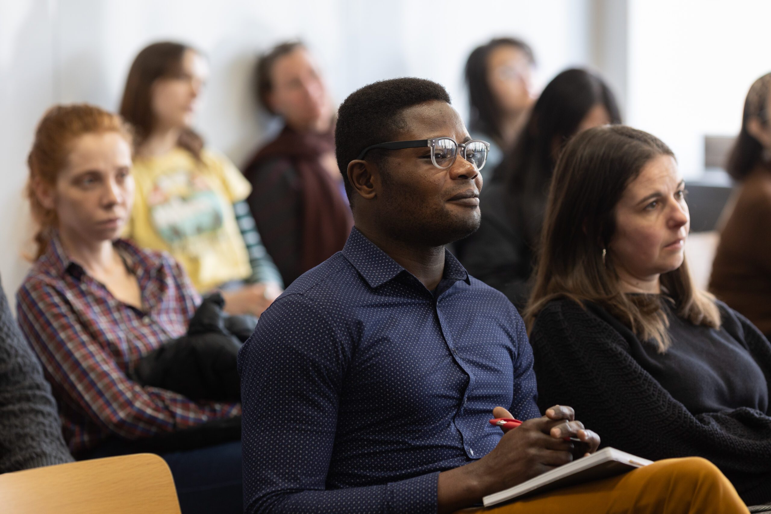 A student in a presentation listening intently to the speaker