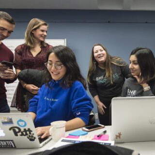 A group of language education students talking together in a classroom