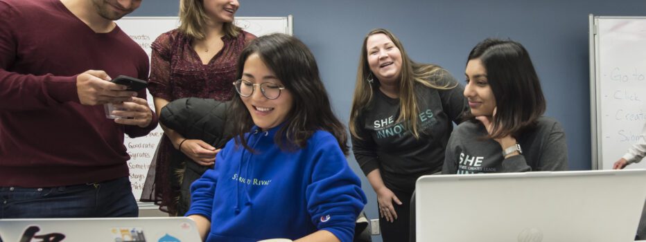 A group of language education students talking together in a classroom