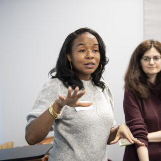 A presenter stands to give a talk at the Community Engagement Center in Homewood in Pittsburgh