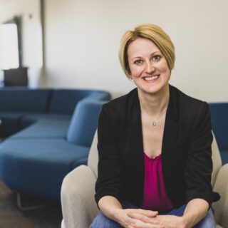 Kate Barnes sitting in welcome center space for picture