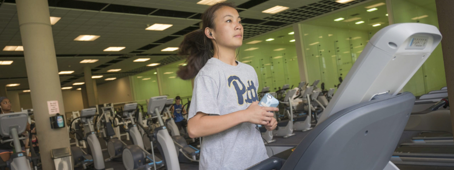 A student running on a treadmill wearing a Pitt T-shirt