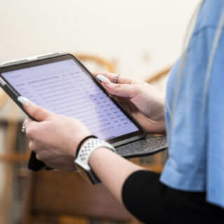 Close-up of a person holding an iPad