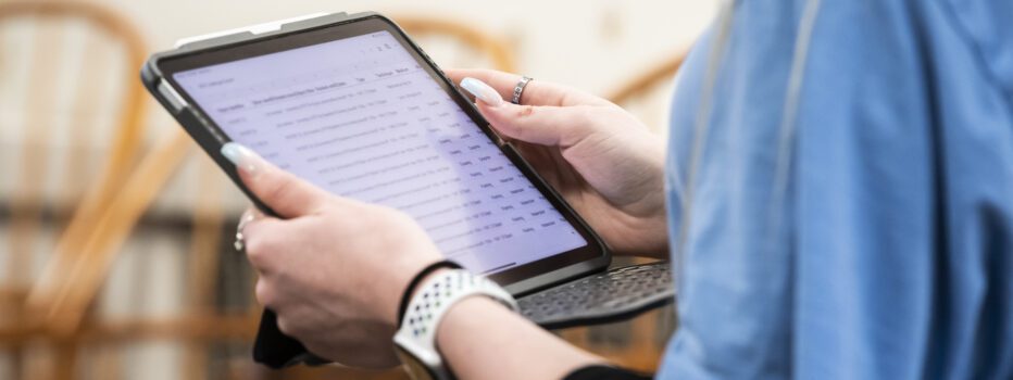 Close-up of a person holding an iPad