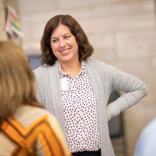 A principal professional speaking to a group of people in a presentation