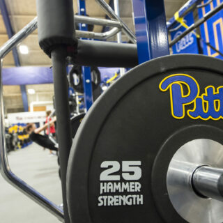 Close-up of a 25-lb weight with a Pitt logo