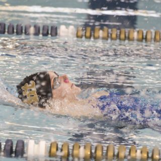 Swimmer doing a backstroke in a pool