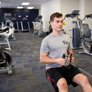 Person does a seated row in a fitness center