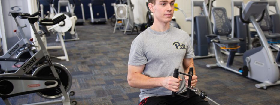 Person does a seated row in a fitness center