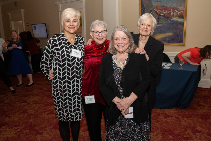 Four people pose for a photo at the 2023 Distinguished Alumni Awards.