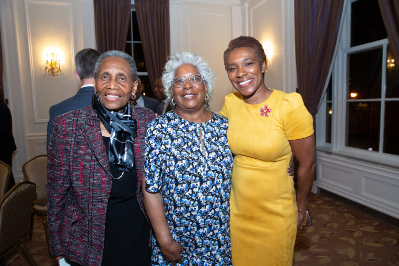 Three people pose for a photo at the 2023 Distinguished Alumni Awards.