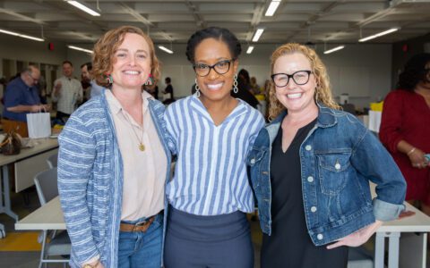 Three faculty members standing together for a picture