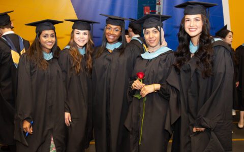 Five students in graduation regalia