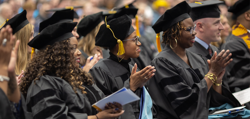 Doctoral students celebrating at the School of Education graduation ceremony