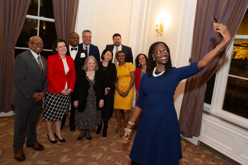 Dean Valerie Kinloch takes a selfie with 2023 Alumni Award winners