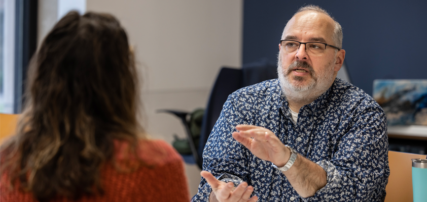 EdD Instructor Mike Gunzenhauser talks with a student