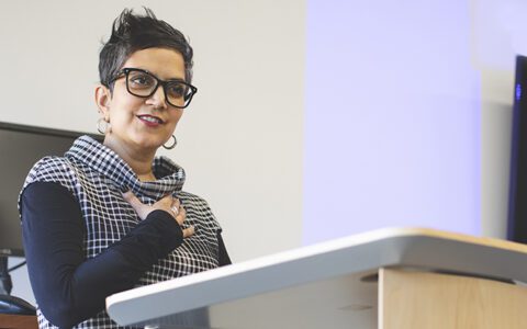 Professor speaking from a podium