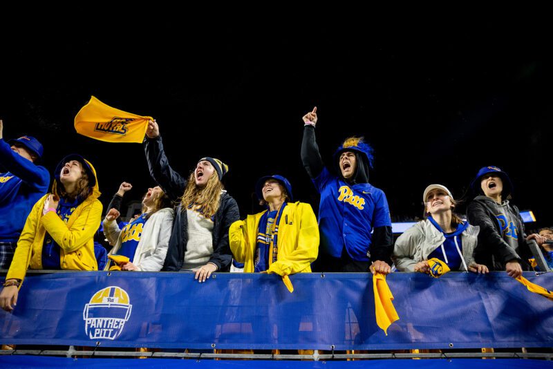 Football fans cheer during the homecoming game