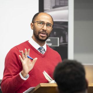 Person presenting at a podium