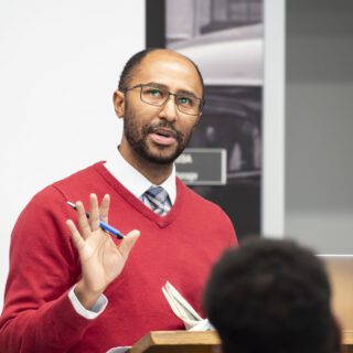 Person presenting at a podium