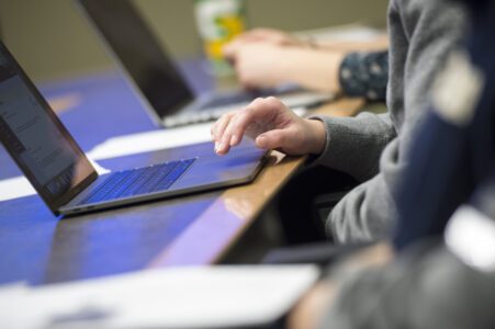 Person typing on a computer to input data