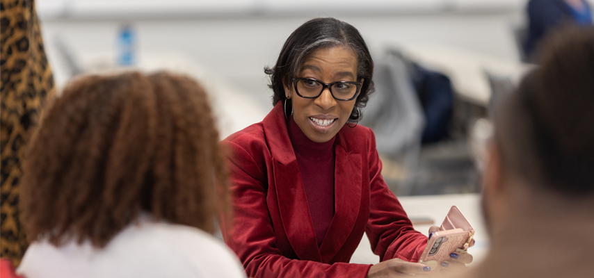 Dr. Eboni M. Zamani-Gallaher speaking to people at an event