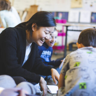 A student teacher in the classroom leading a group of students