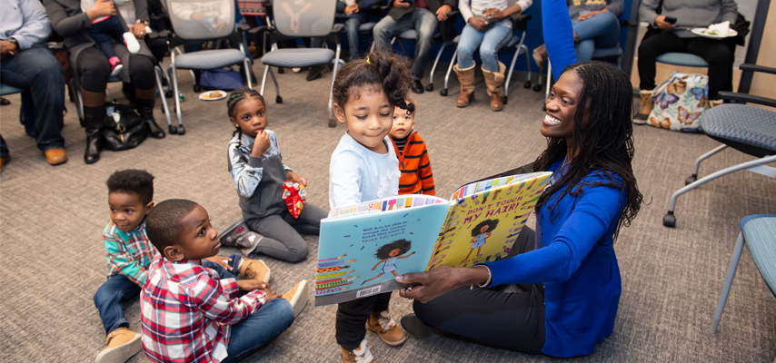 Former Dean Valerie Kinloch reading to young children at the Pitt Community Engagement Center