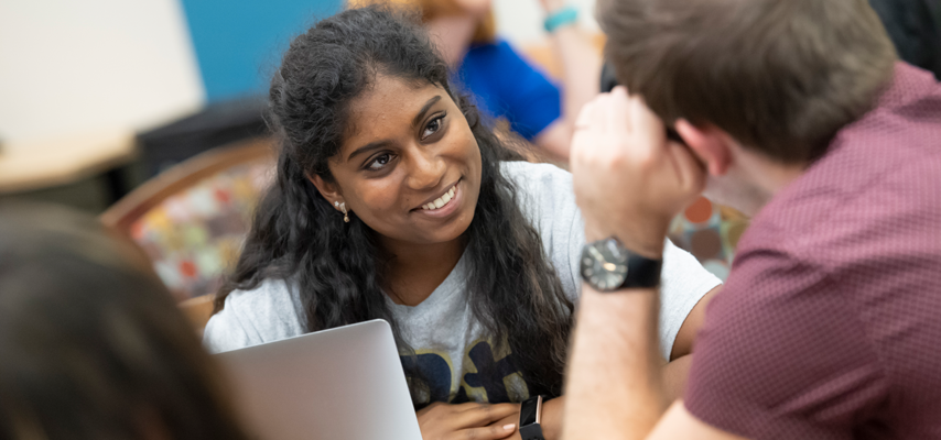 An international student speaking with her classmates at Pitt