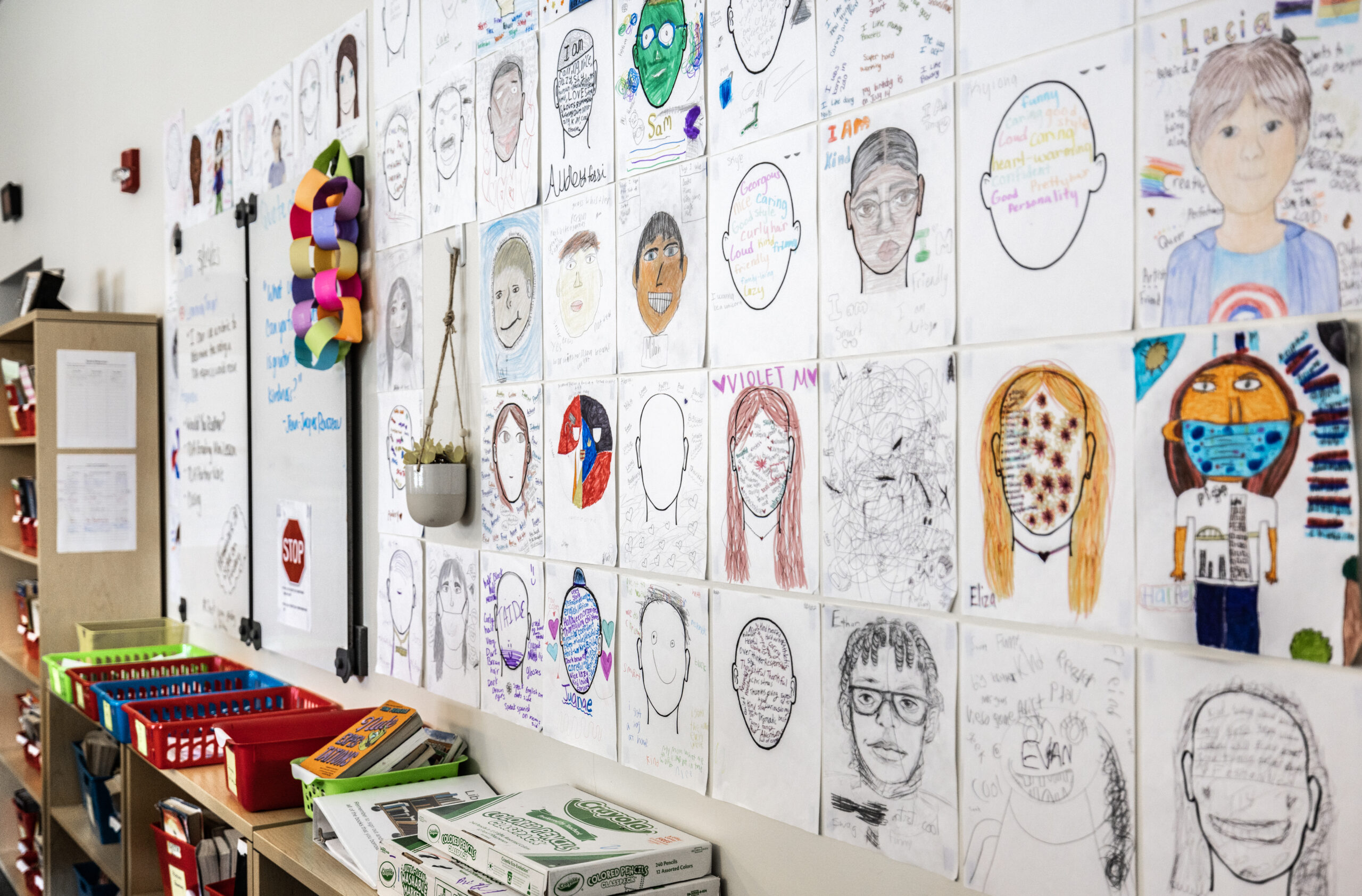 http://A%20classroom%20wall%20featuring%20a%20few%20dozen%20self-portraits%20drawn%20by%20students.