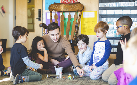 Student teacher and group of young students