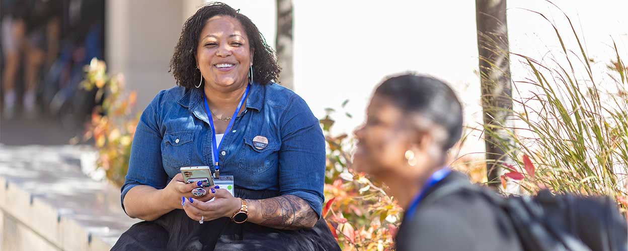 A woman smiling outside for the Transfer Summit Pathway