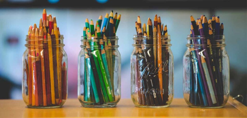 Colored pencils in glass jars