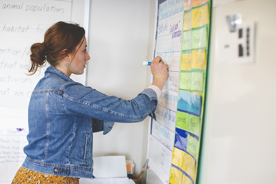 http://A%20student-teacher%20writes%20on%20a%20whiteboard%20in%20a%20classroom