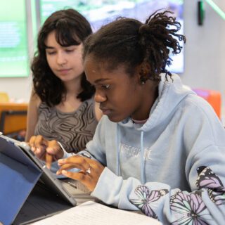 Young Writers Institute camper typing on a tablet
