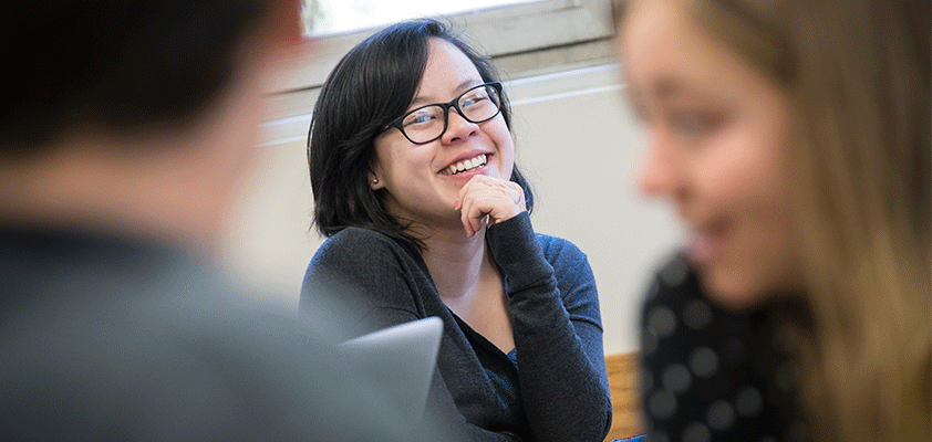A woman in a room smiling 
