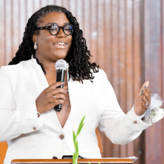 Khirsten Scott speaking at a lectern.