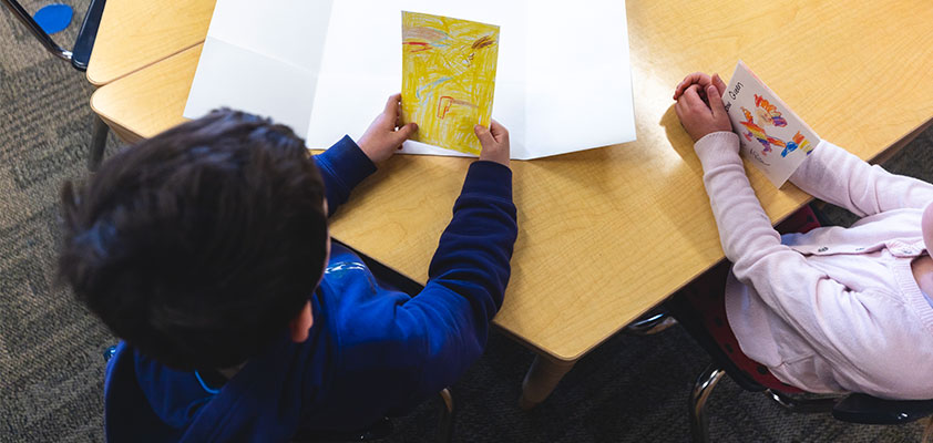 Overhead picture of two students looking at papers