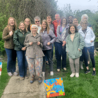 Denise Esposto poses for a photo with a group of many of her former students and mentees, now employed as Child Life Specialists.