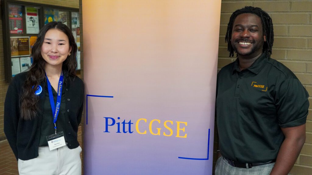 Photo of CGSE Leadership pose in front of a banner for the student organization.