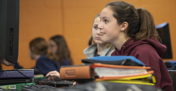 A teenage girl learning at a computer