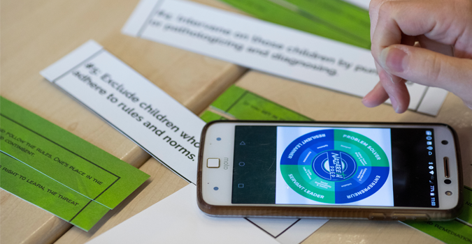 A teacher using a phone to learn materials